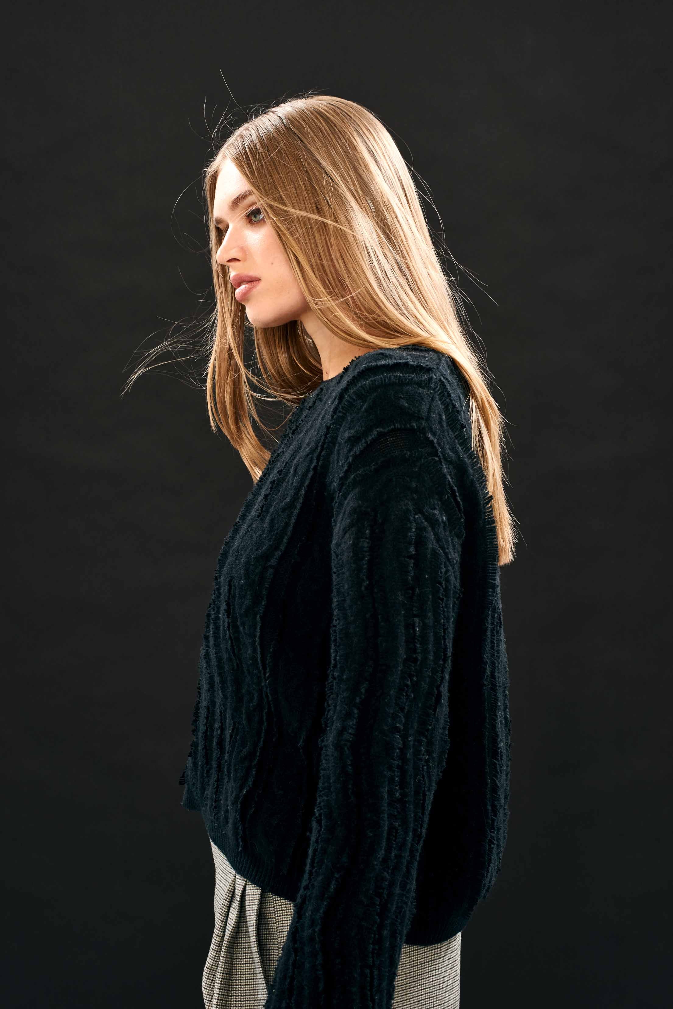 Female model wearing Jumper 1234 Black crew neck jumper in our wonderful cashmere and wool blend with all over raw cut cable detail slightly oversized fit