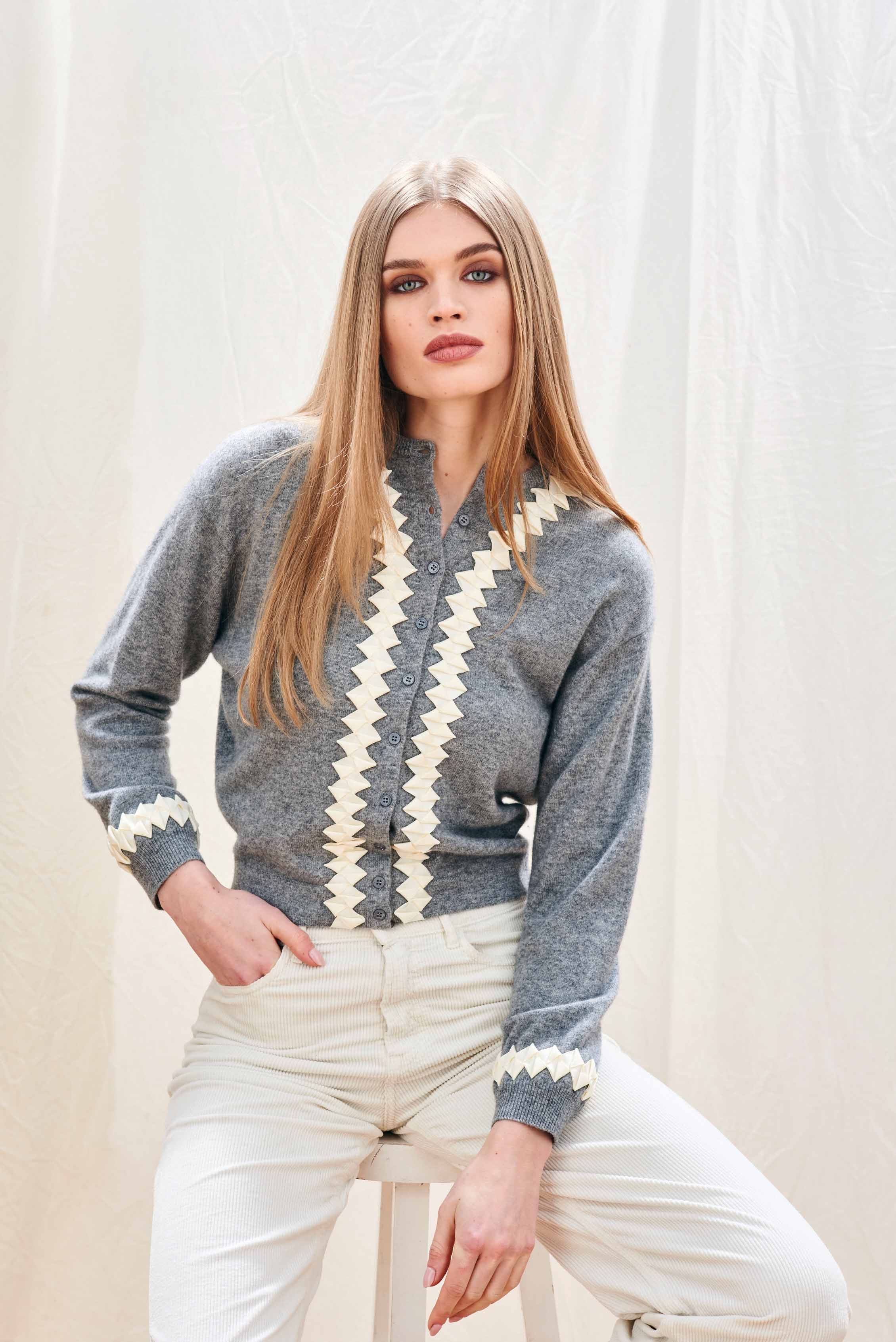 Female model wearing Jumper 1234 cashmere wool neat fit crew neck cardigan in mid grey with cream twisted ribbon detail