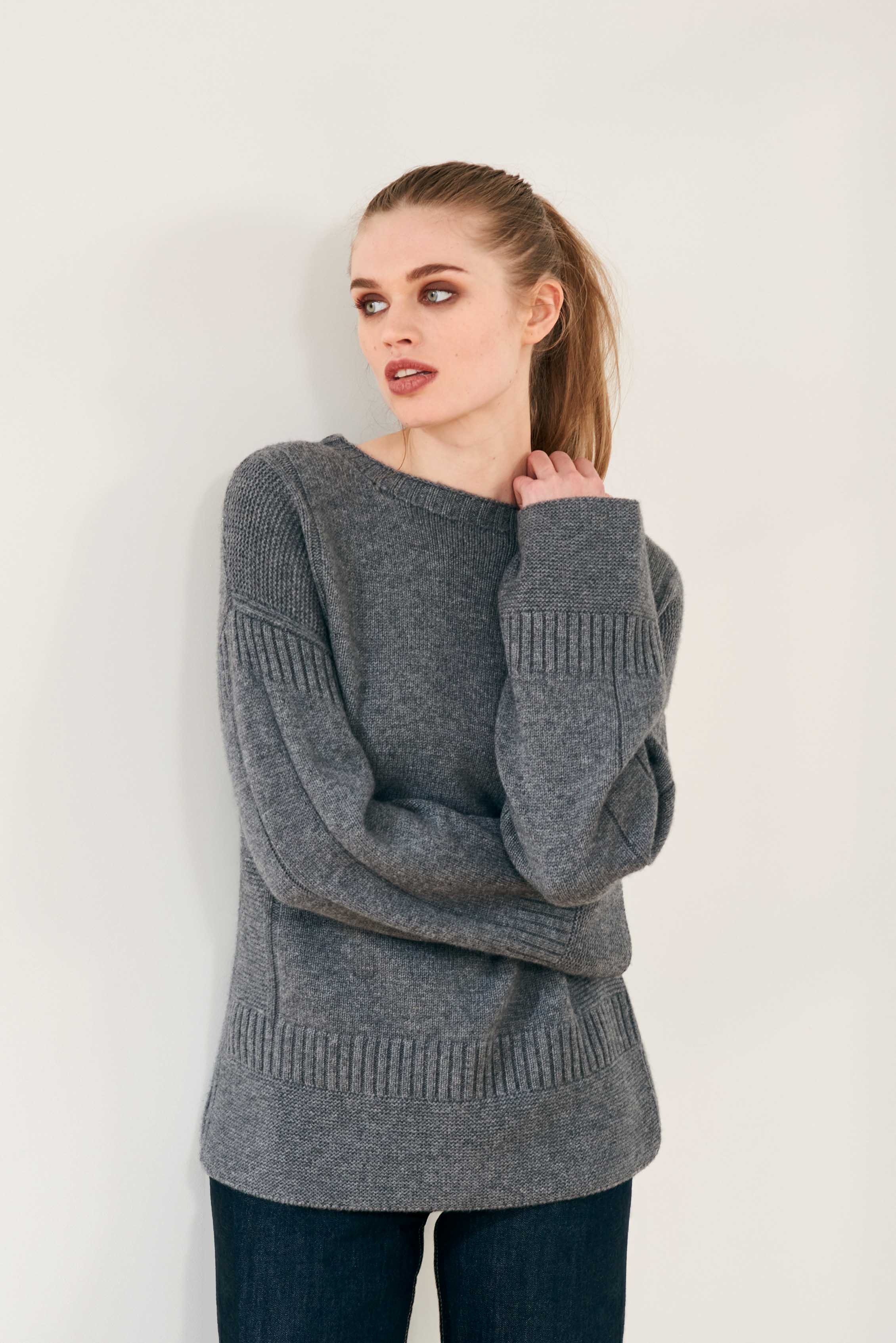 Female model wearing Jumper 1234 cashmere wool charcoal grey oversize jumper with guernsey details and trumpet sleeves