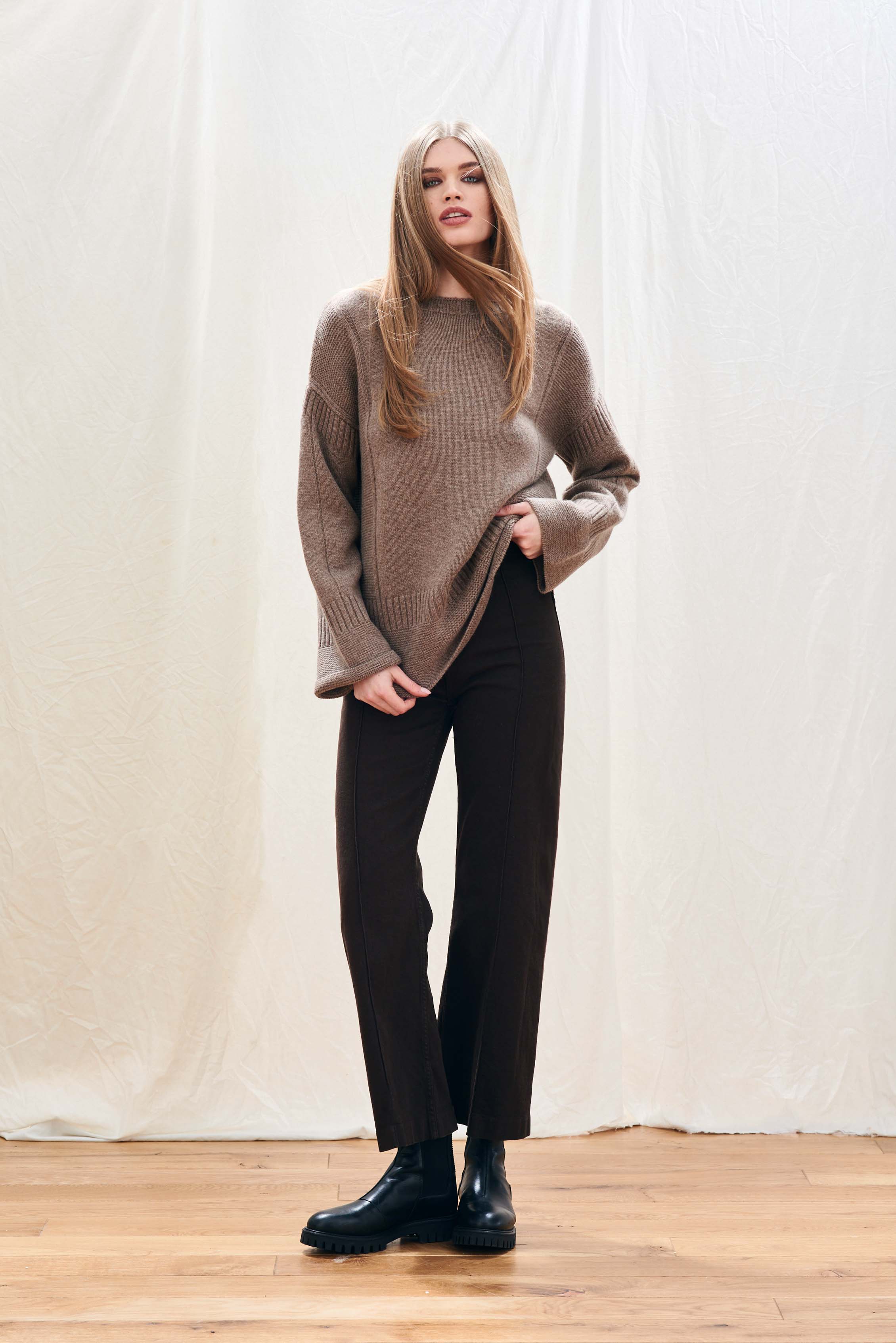 Female model wearing Jumper 1234 cashmere wool mid brown oversize jumper with guernsey details and trumpet sleeves