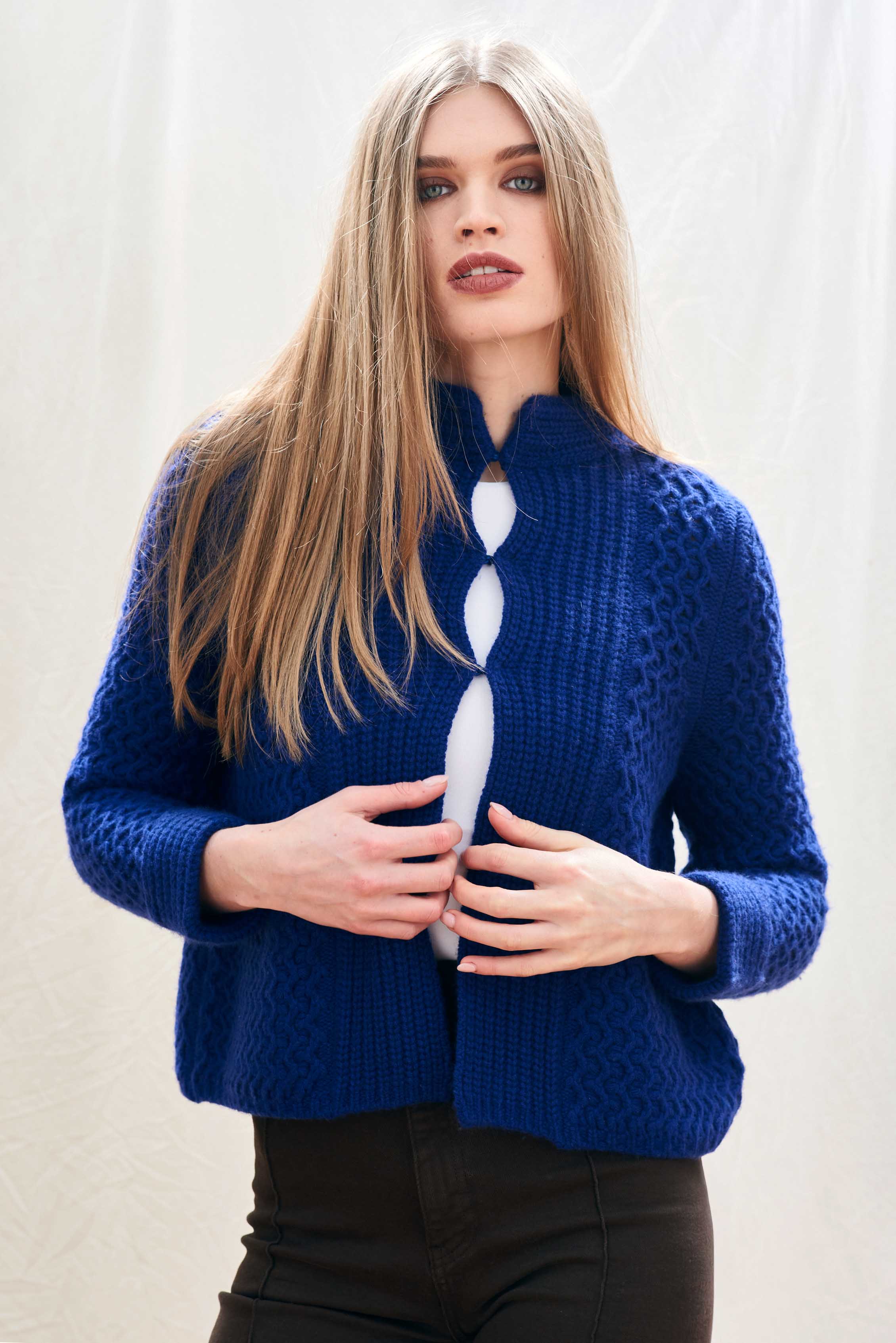 Female model wearing Jumper 1234 bright blue heavy weight textured cardigan in cashmere wool, with hook and eye closure