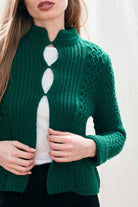 Female model wearing Jumper 1234 green heavy weight textured cardigan in cashmere wool, with hook and eye closure