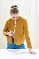 Female model wearing Jumper 1234 mustard yellow heavy weight textured cardigan in cashmere wool, with hook and eye closure