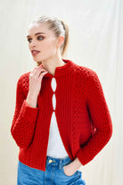 Female model wearing Jumper 1234 red heavy weight textured cardigan in cashmere wool, with hook and eye closure