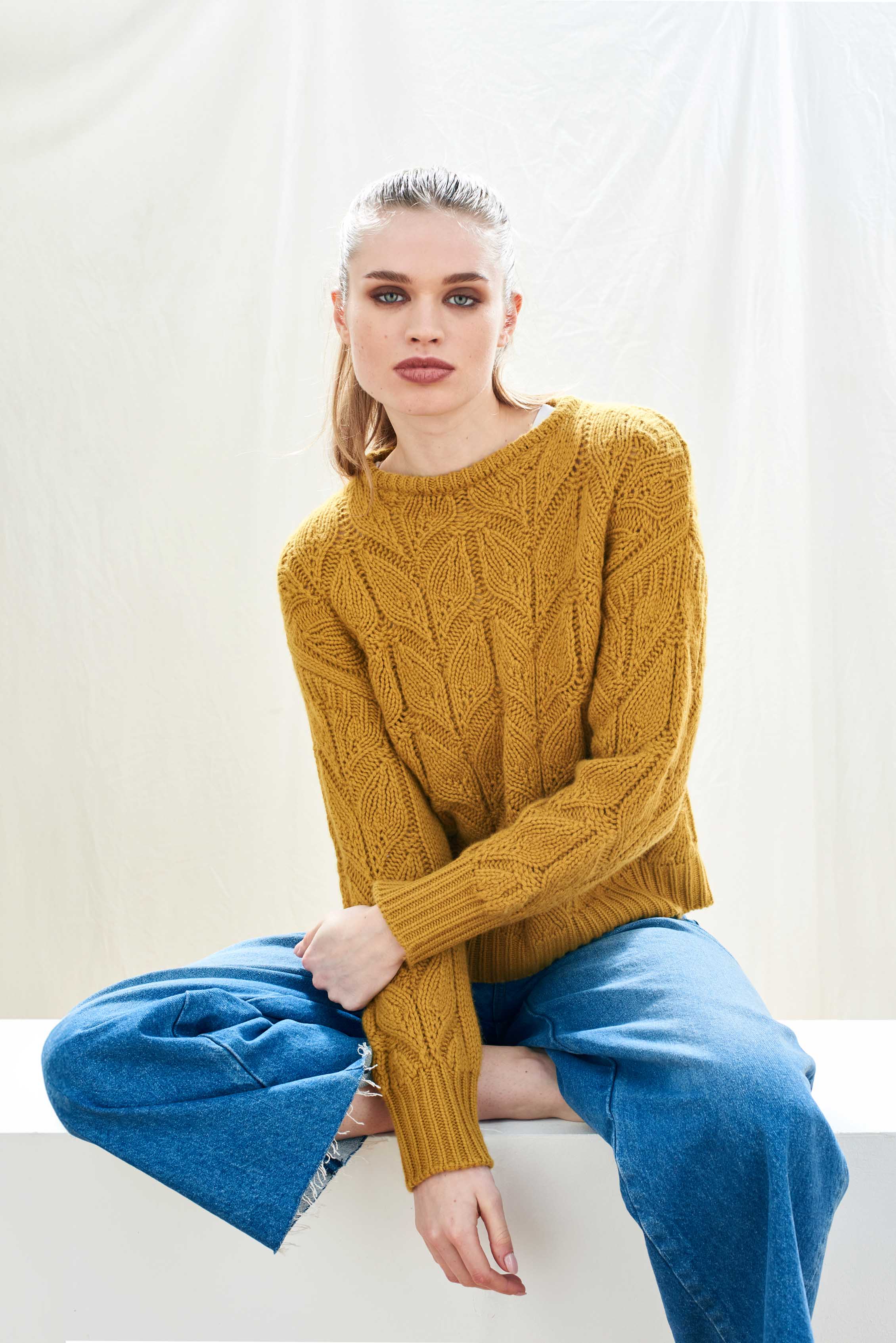 Female model wearing Jumper1234 mustard yellow heavy weight 'leaf' textured crew neck jumper in cashmere wool