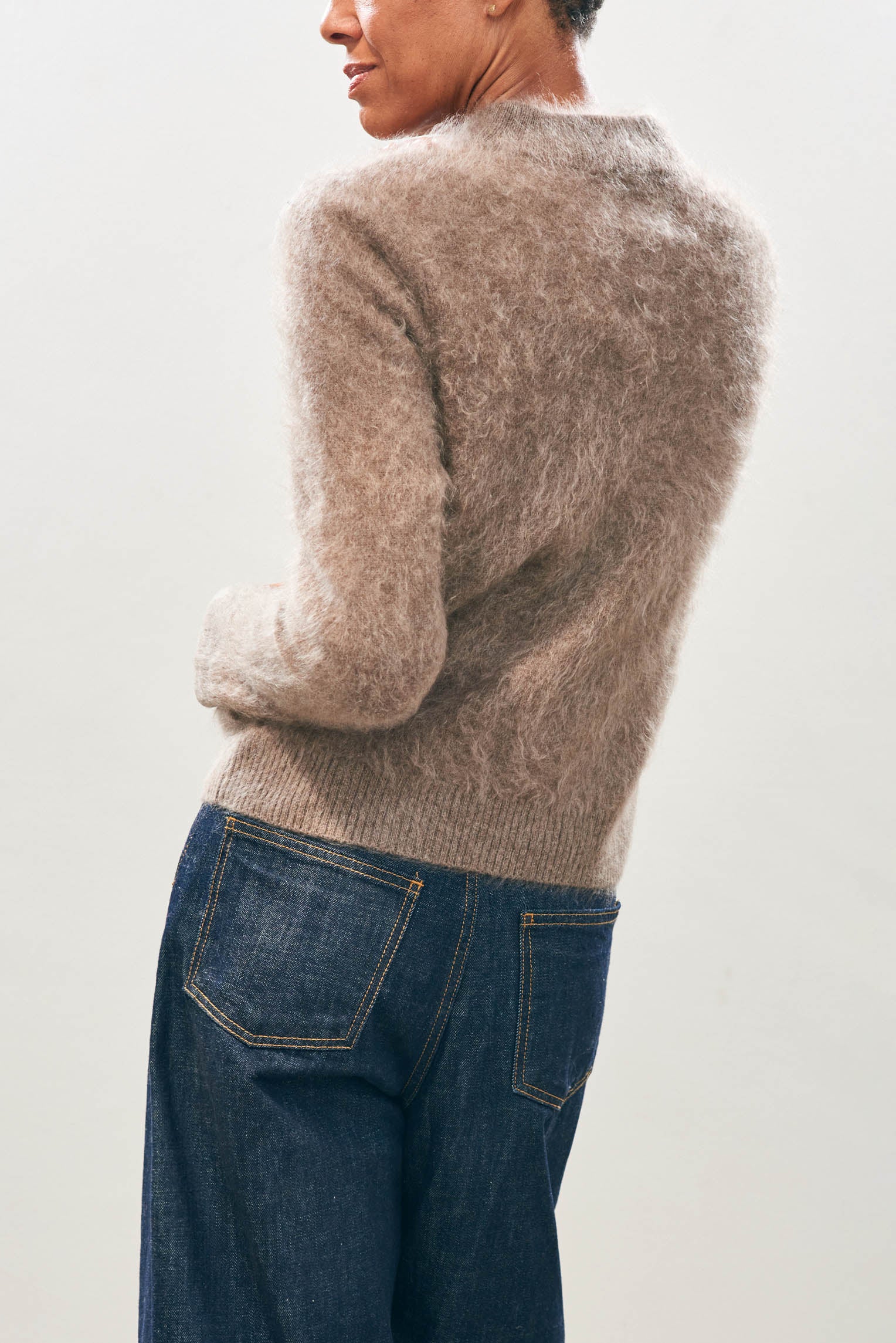 Female model wearing Jumper1234 Cashmere Brushed Turtle in Moose facing away from the camera