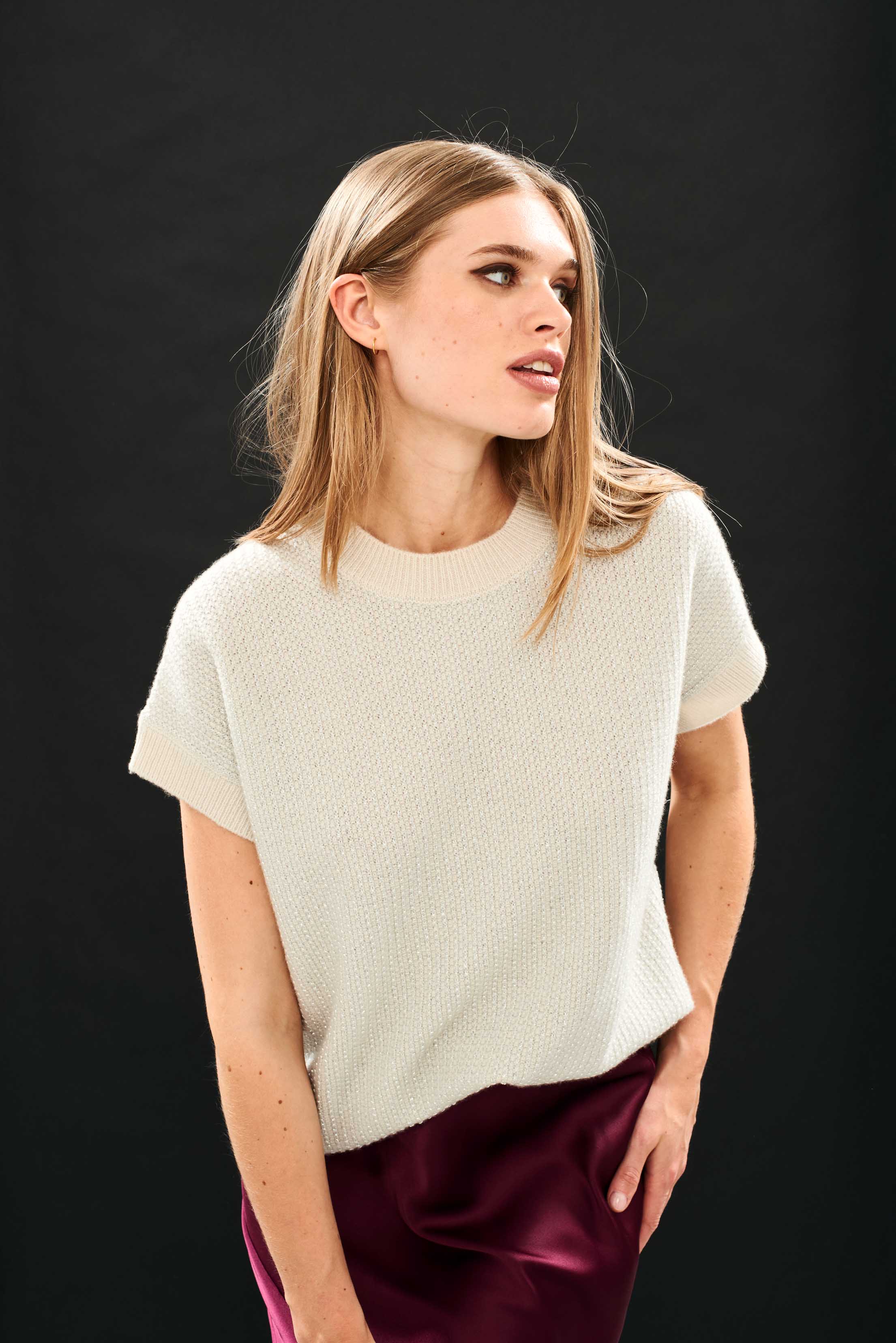 Female model wearing Jumper 1234 Oversize cashmere and wool tank in stone with silver lurex running through the birdseye texture.