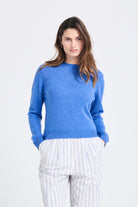 Brown haired female model wearing Jumper1234 Periwinkle blue lighter weight crew neck cashmere jumper