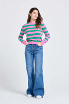 Brown haired female model wearing Jumper1234 Stripe cashmere crew neck jumper in peony and bright green