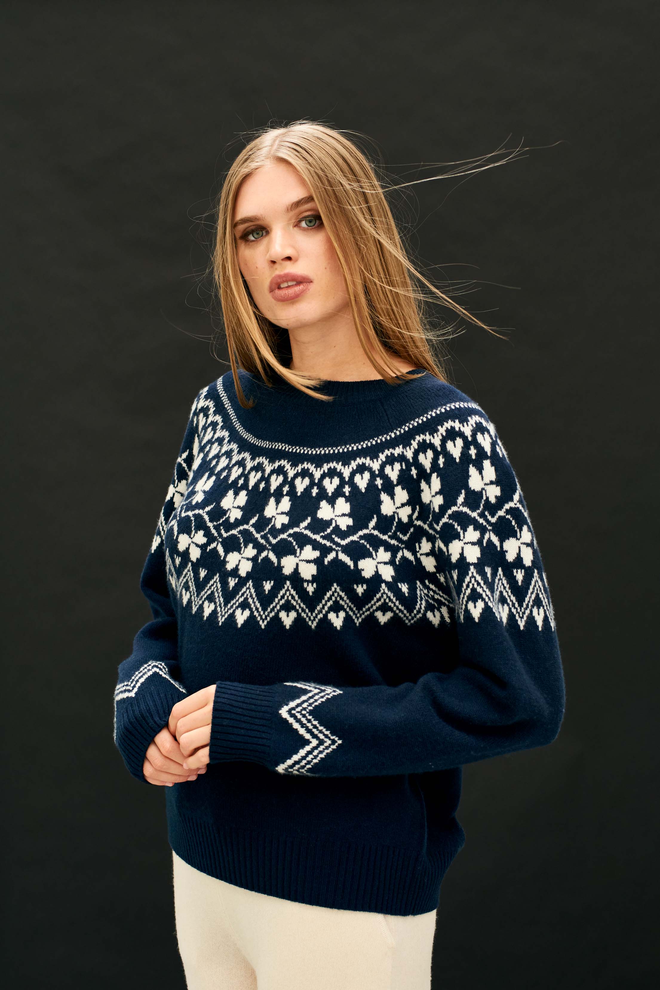 Female model wearing Jumper 1234 navy crew neck jumper in our heavier weight cashmere and wool with a stone clover pattern on the yoke, back and front