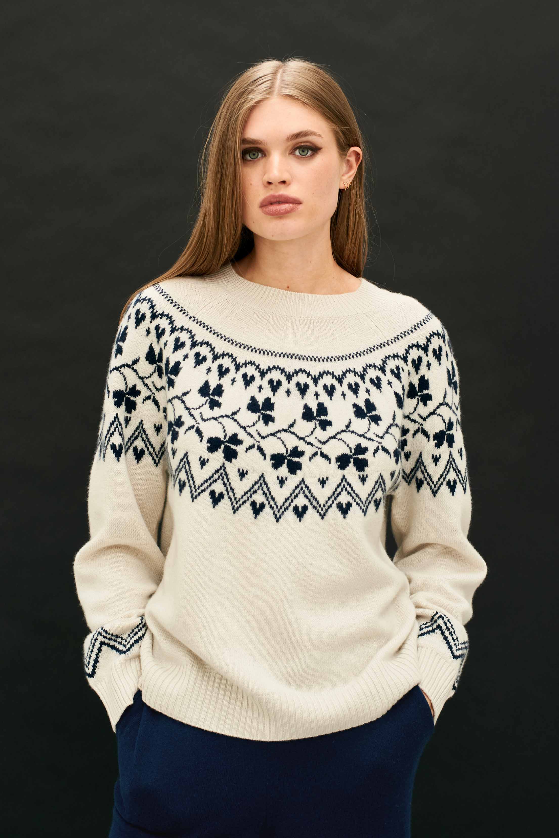 Female model wearing Jumper 1234 cream crew neck jumper in our heavier weight cashmere and wool with a navy clover pattern on the yoke, back and front