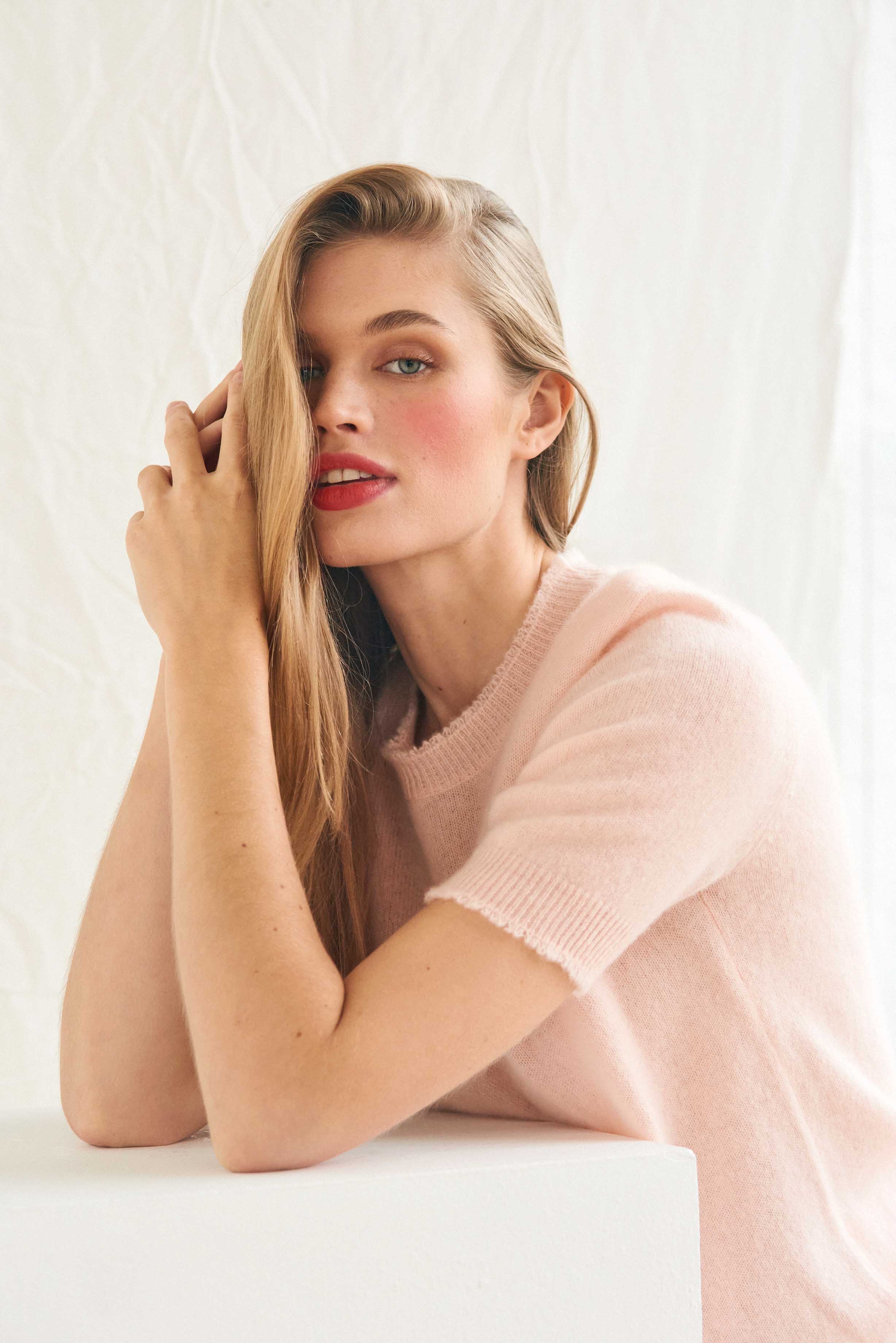 Female model wearing Jumper 1234 Pale pink short sleeve cashmere jumper with 'distressed' ribs.