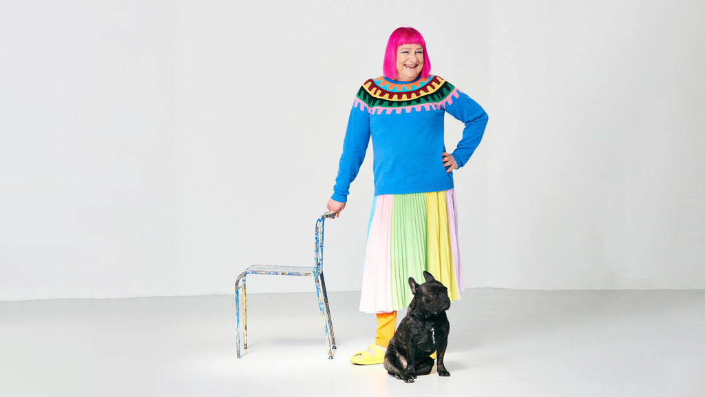 Bernie Yates desginer of the Rock Rack Yoke and design teacher at Central Stain Martins with her frenchie wearing the jumper she designed and colourful clothing
