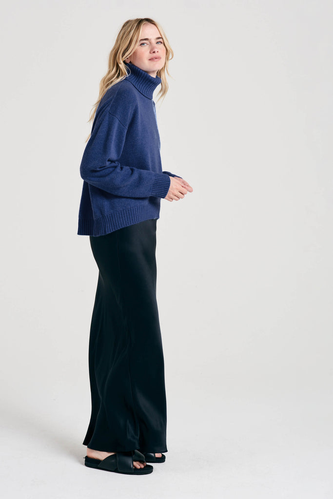 Blonde female model wearing Jumper1234 oversized cashmere roll collar in Denim