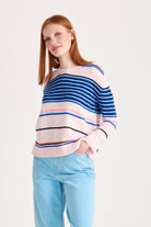 Red haired female model wearing Jumper1234 Cashmere multi stripe crew neck jumper in pale pink
