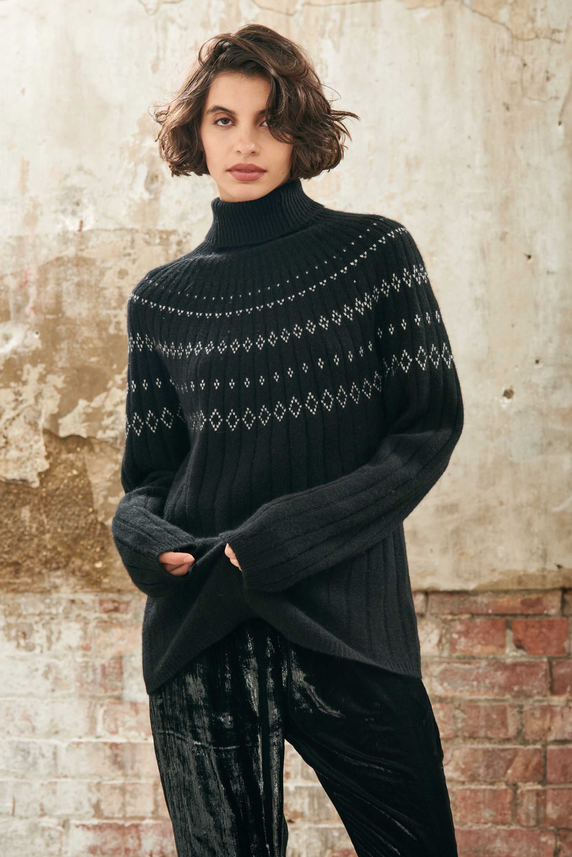 Female model wearing Jumper1234 Cashmere Rib Ski Roll Collar in Black and Cream with fair isle pattern on front and back yolk 