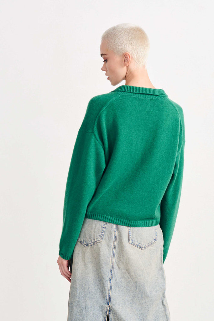 Blonde female model wearing Jumper1234 crop collar crew in Grass Green facing away from the camera