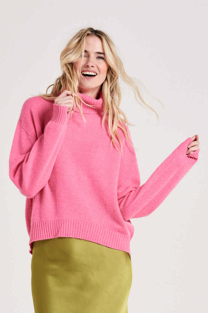 Blonde female model wearing Jumper1234 oversized cashmere roll collar in candy pink 