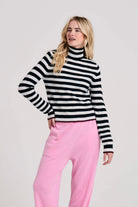 Blonde female model wearing Jumper1234 little stripe cashmere roll collar in black and marble with pecan tipping