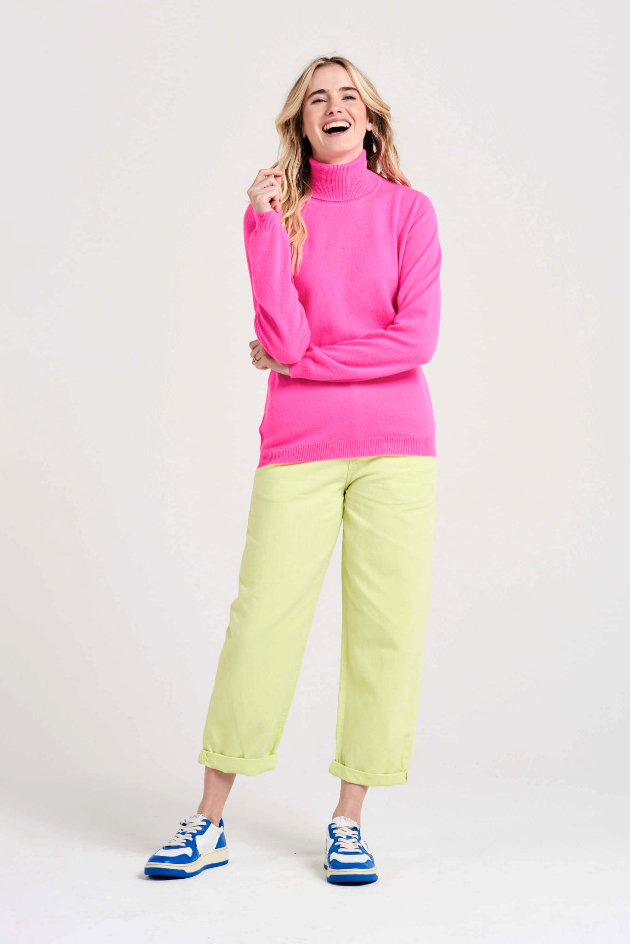 Blonde female model wearing Jumper1234 hot pink cashmere roll neck