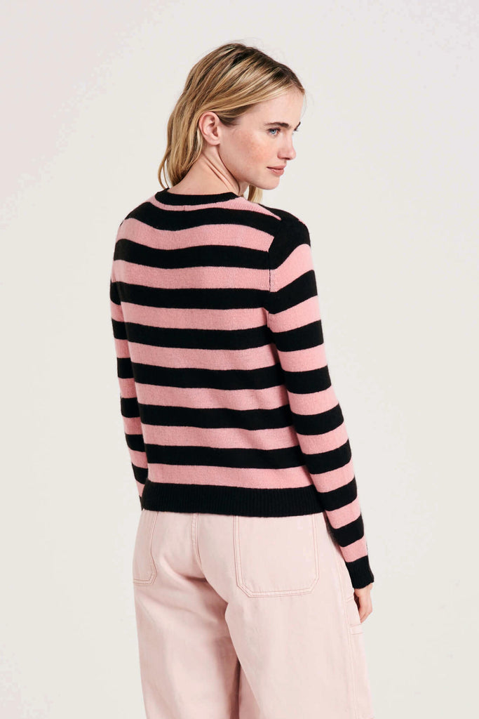 Blonde female model wearing Jumper1234 stripe cashmere crew in dark brown and pink facing away from the camera