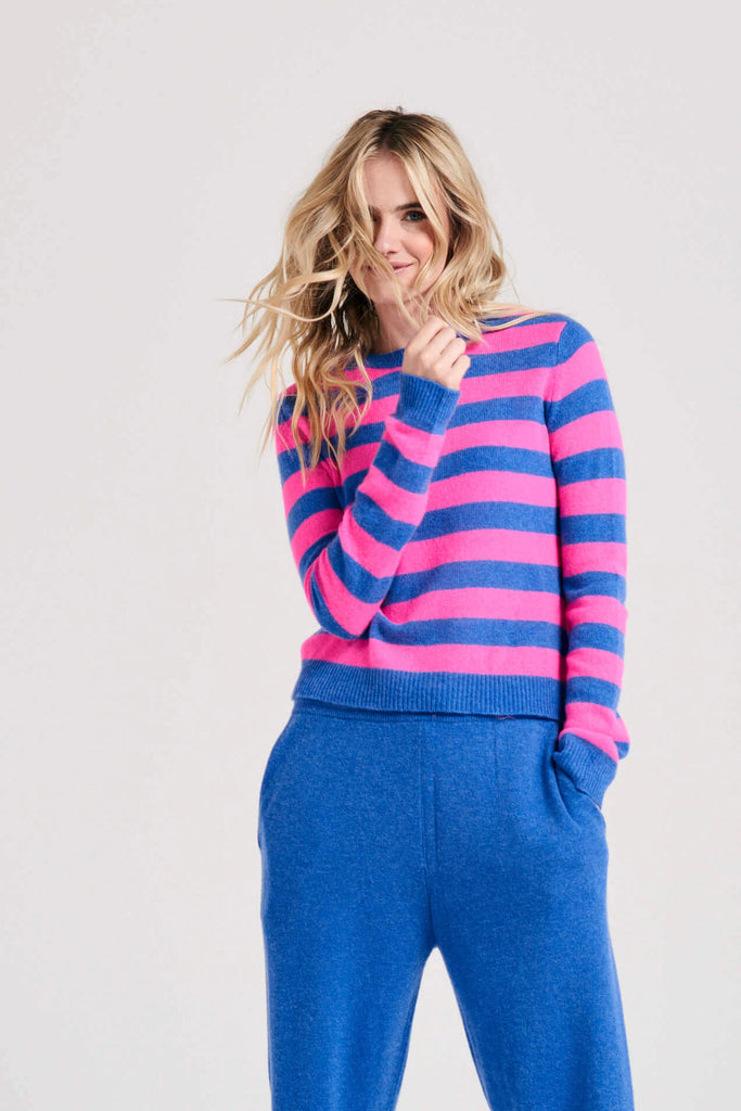 Blonde female model wearing Jumper1234 stripe cashmere crew in periwinkle and hot pink