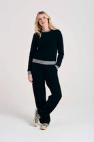 Blonde female model wearing Jumper1234 black cashmere crew neck with mid grey ribs