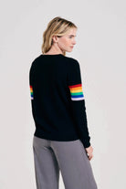 Blonde female model wearing Jumper1234 Rainbow arms cashmere crew in black facing away from the camera