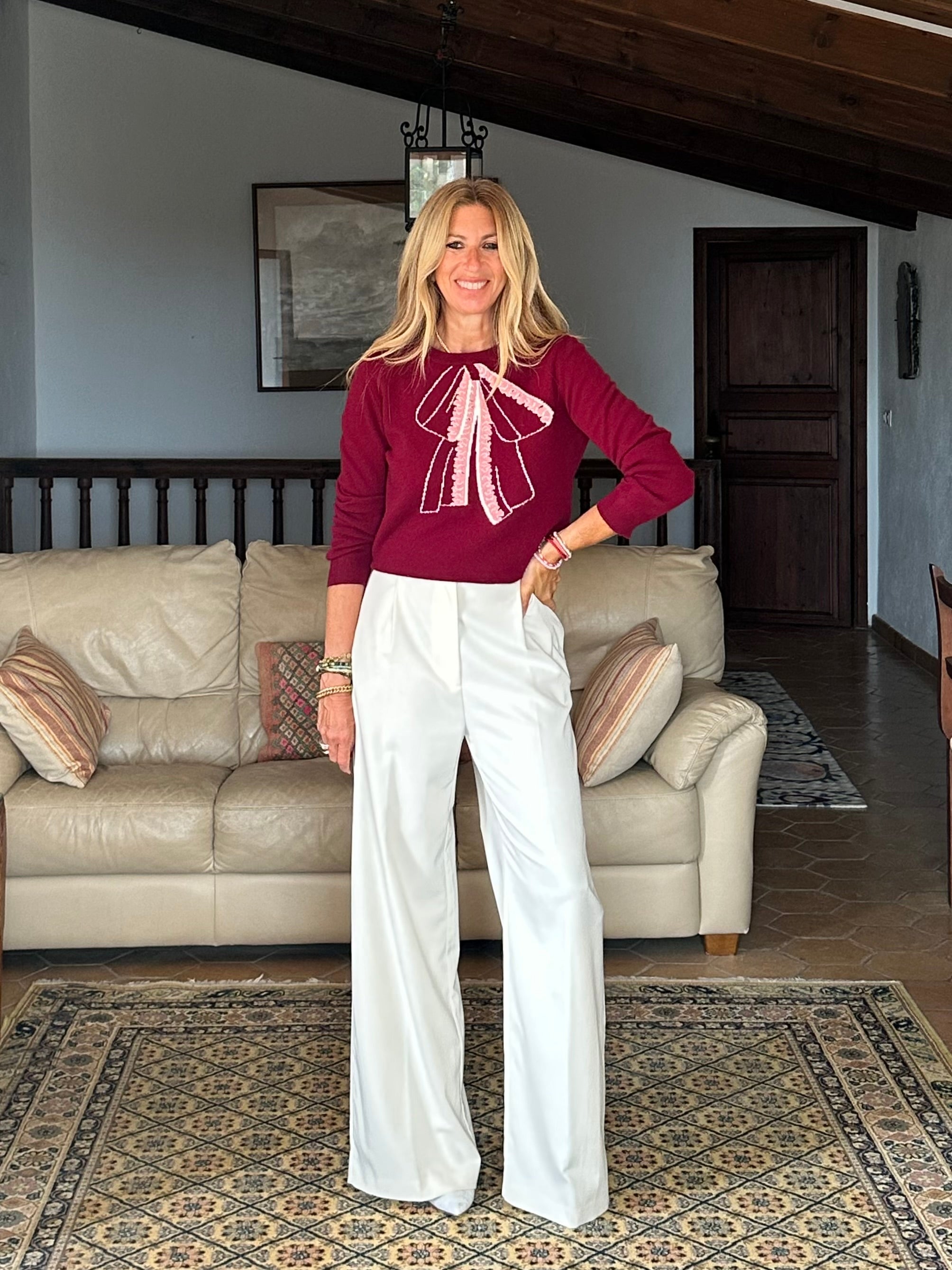 Gayle Rinkoff wearing Jumper1234 Burgundy classic fit crew neck jumper with folklore-inspired intarsia bow in pink and cream