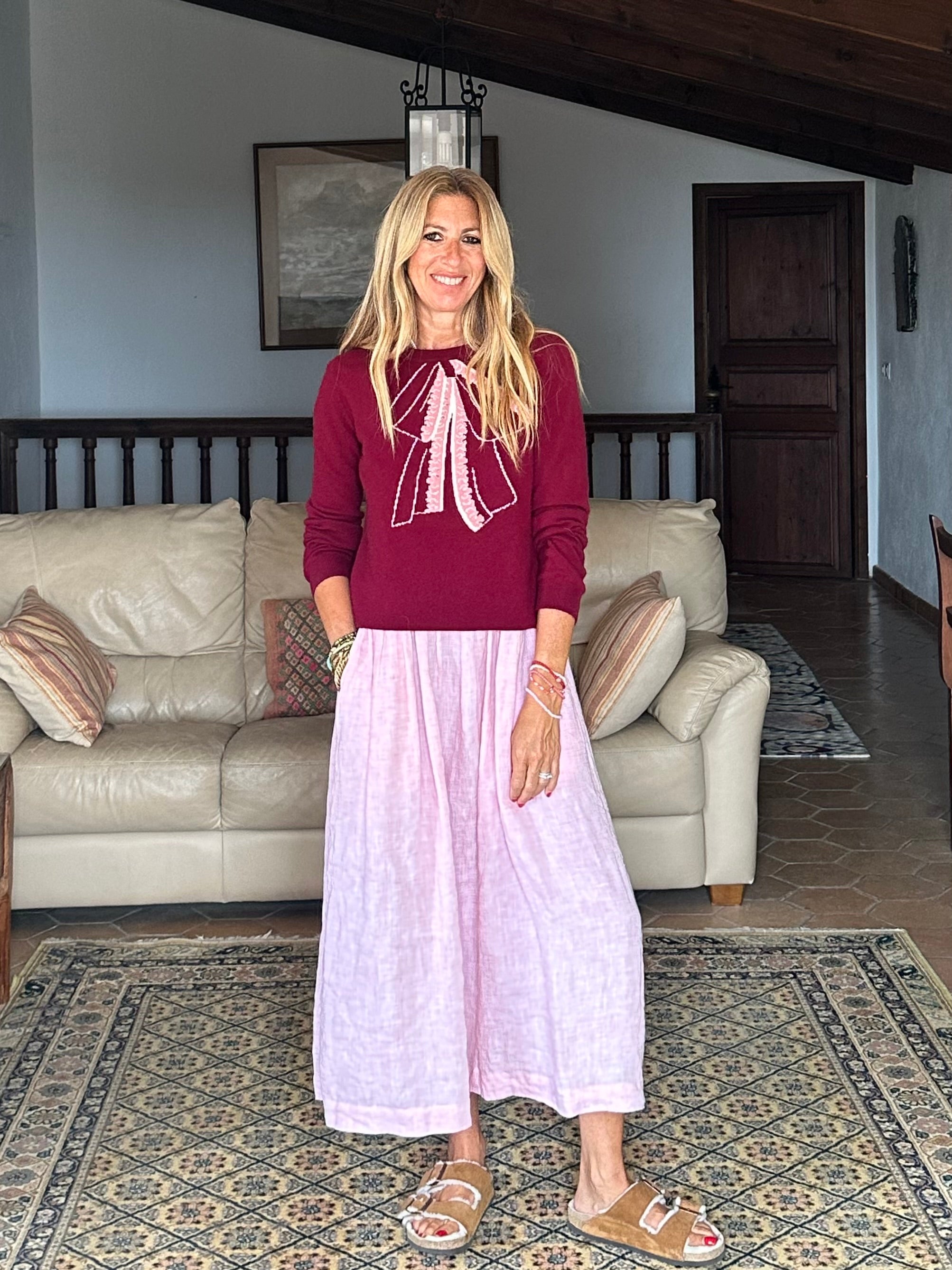 Gayle Rinkoff wearing Jumper1234 Burgundy classic fit crew neck jumper with folklore-inspired intarsia bow in pink and cream