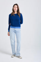 Brown haired female model wearing Jumper1234 denim cashmere crew neck jumper with periwinkle contrast ribs