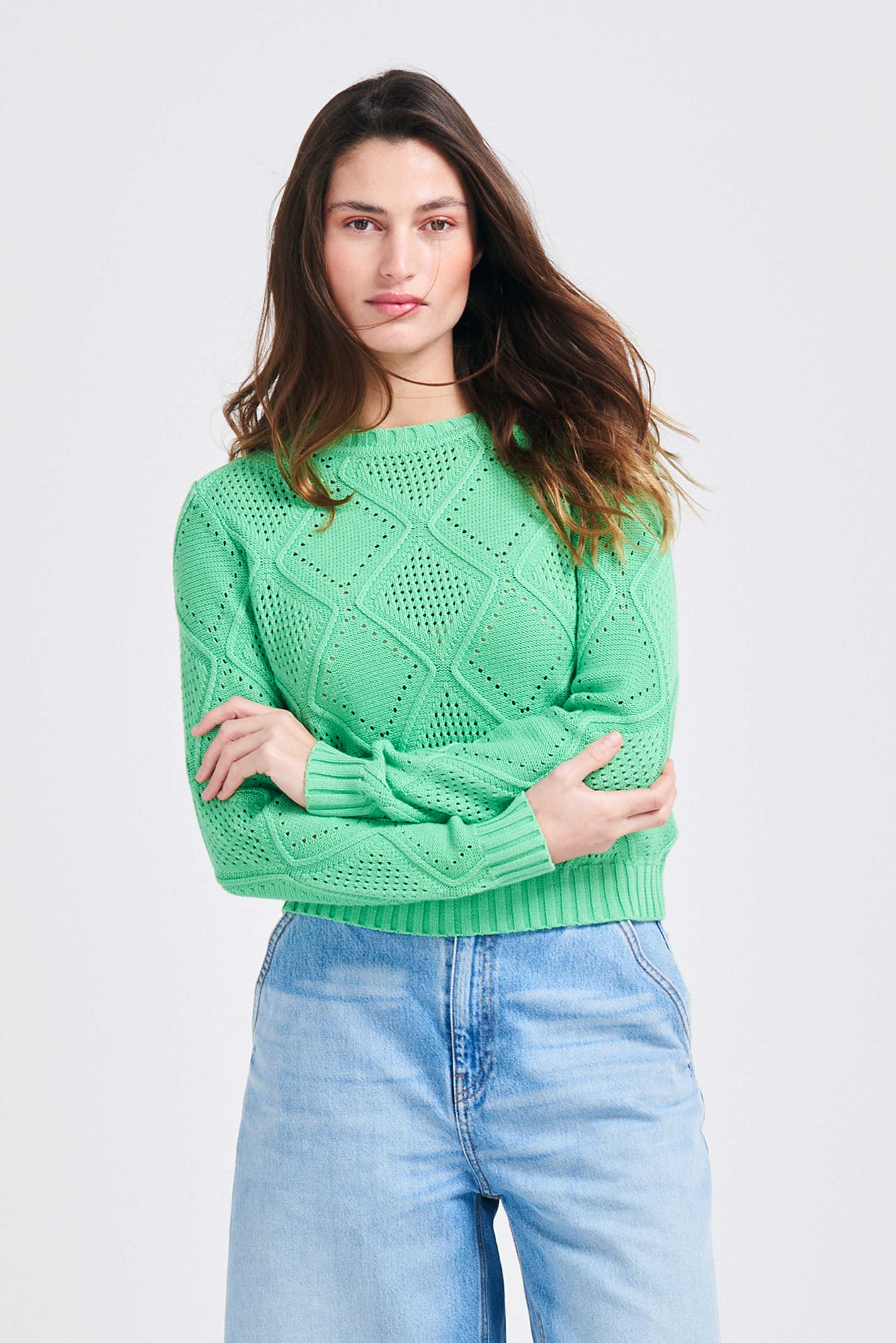 Brown haired female model wearing Jumper1234 Apple green cotton crew neck jumper with a diamond texture stitch pattern