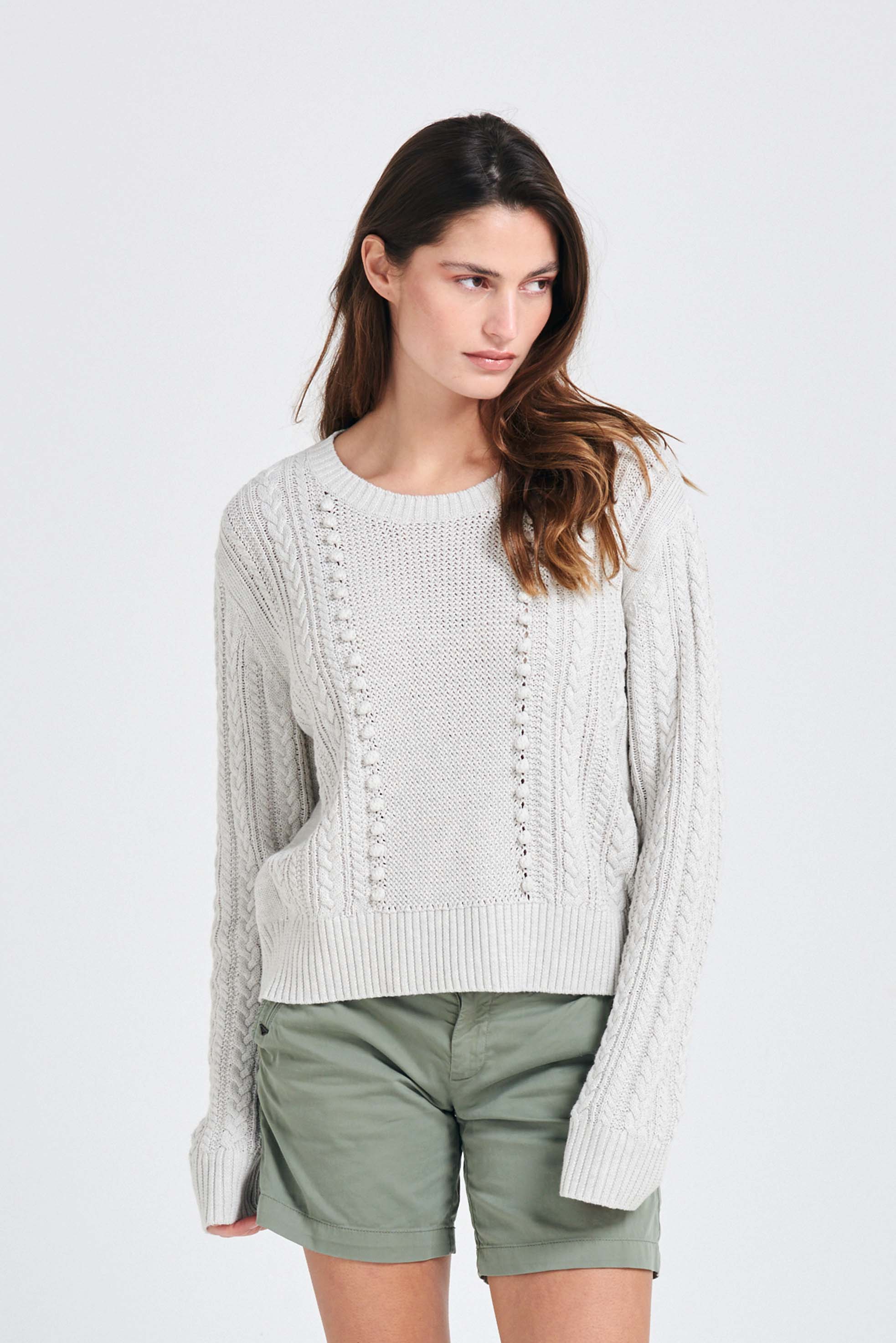 Brown haired female model wearing Jumper1234 Silver marl cotton aran crew neck jumper with a ribbon tie back