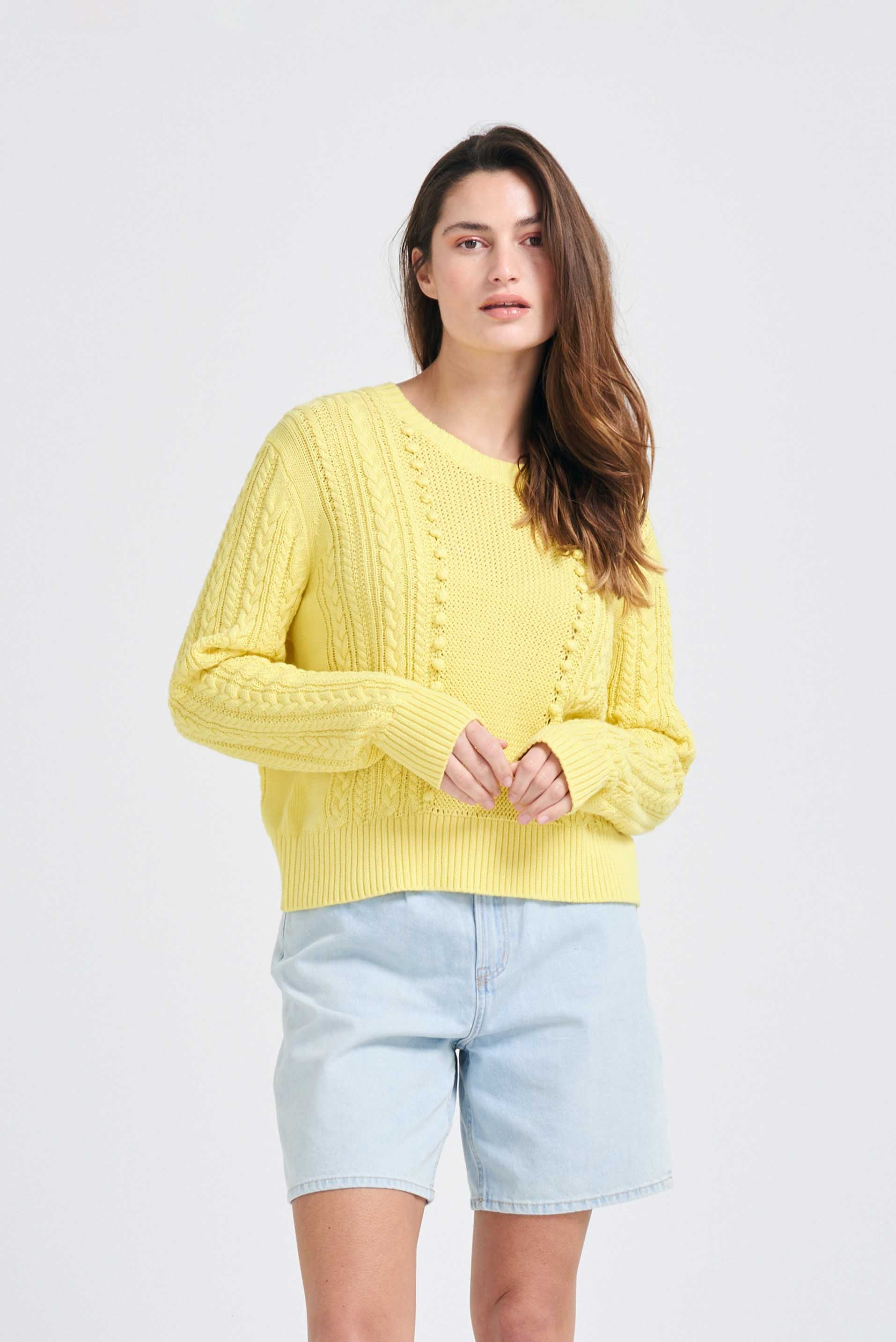 Brown haired female model wearing Jumper1234 Yellow cotton aran crew neck jumper with a ribbon tie back, back shot