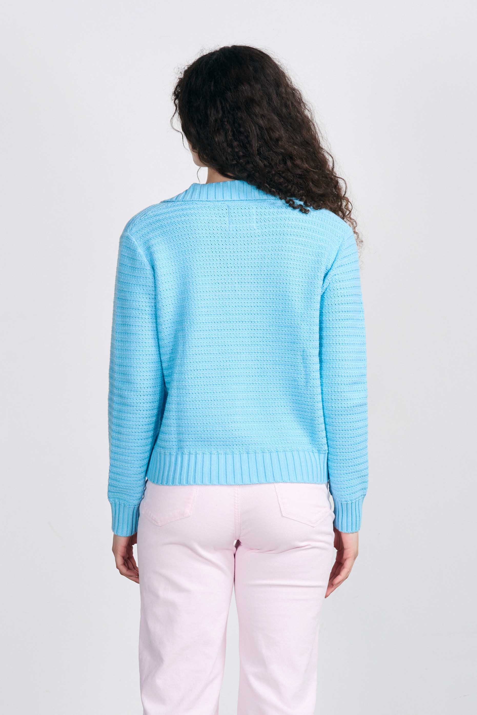 Brown haired female model wearing Jumper1234 Opal blue cotton jumper with a collar in a fabulous all over herringbone stitch facing away from the camera