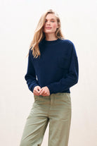 Female model wearing Jumper 1234 Heavier weight cashmere turtle neck jumper in navy with an oversize slightly cropped fit