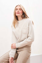 Female model wearing Jumper 1234 Heavier weight cashmere turtle neck jumper in navy with an oversize slightly cropped fit