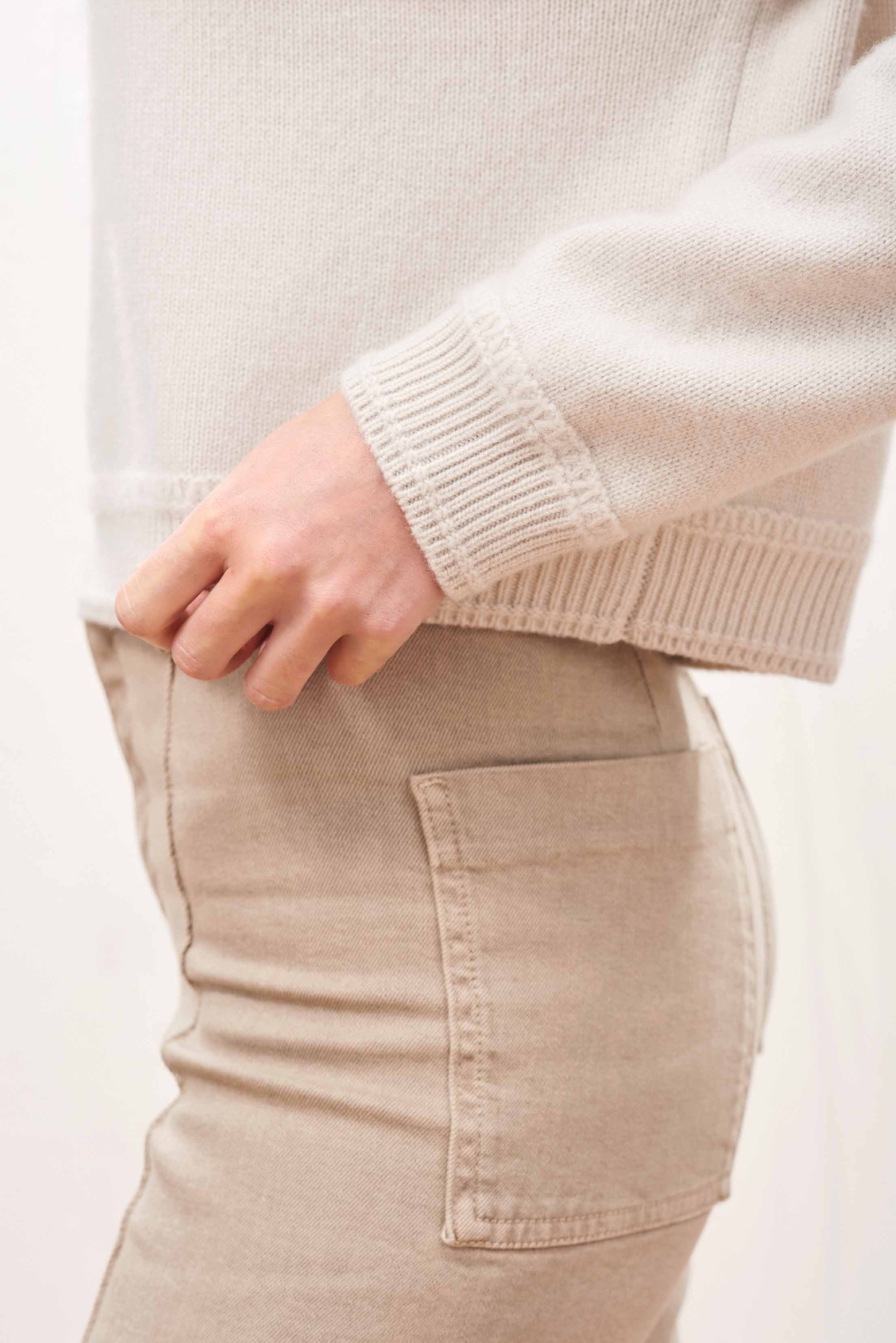Female model wearing Jumper 1234 Heavier weight cashmere turtle neck jumper in navy with an oversize slightly cropped fit. Close up rib detail