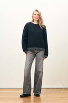 Female model wearing Jumper 1234 hand knitted mohair and wool blend hand knitted crew neck jumper in black with charcoal tipping.