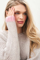 Female model wearing Jumper 1234 hand knitted mohair and wool blend hand knitted crew neck jumper in oyster with pink tipping close up.