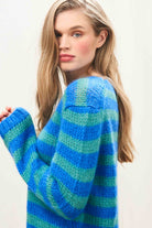 Female model wearing Jumper 1234 hand knitted mohair and wool blend hand knitted crew neck jumper in blue and green stripes.