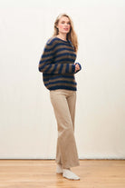 Female model wearing Jumper 1234 hand knitted mohair and wool blend hand knitted crew neck jumper in navy and chocolate stripes.