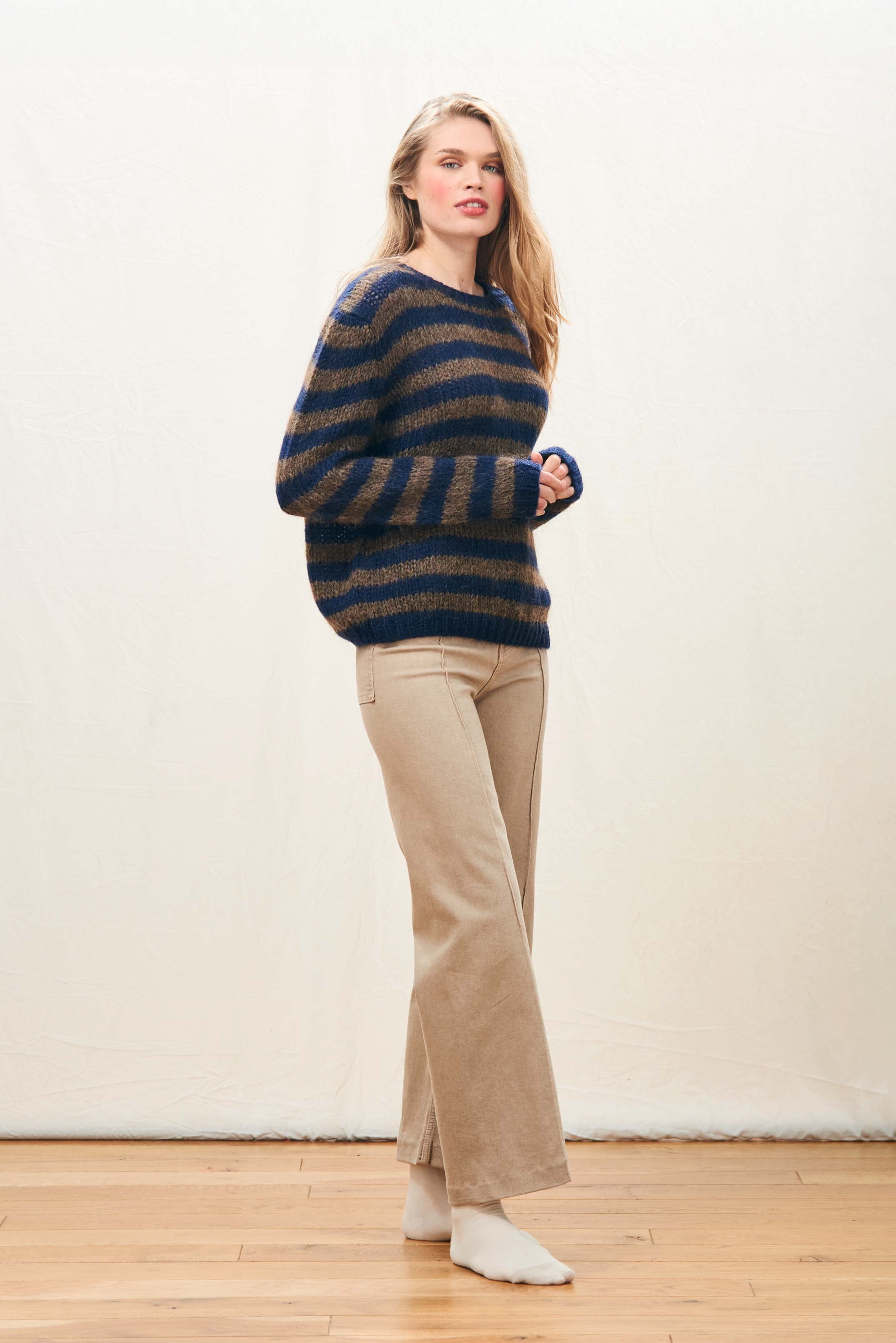 Female model wearing Jumper 1234 hand knitted mohair and wool blend hand knitted crew neck jumper in navy and chocolate stripes.