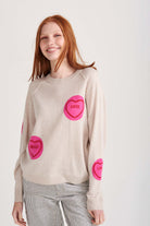 Red haired female model wearing Jumper1234 oatmeal cashmere and wool mix crew neck sweatshirt style jumper with all over pink and red love hearts intarsia