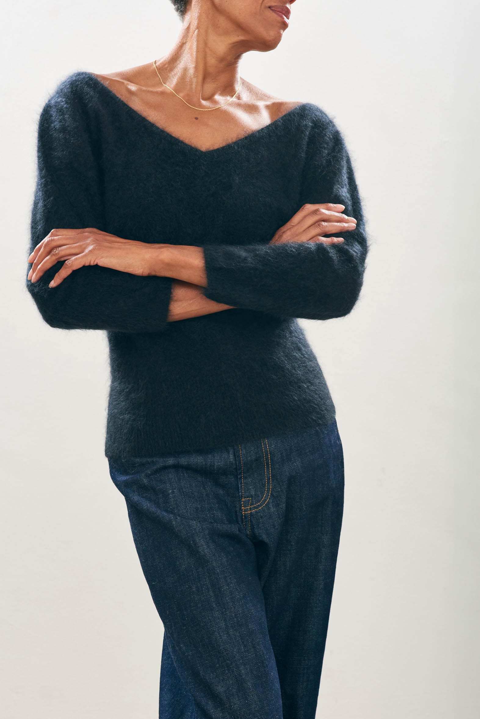 Female model wearing Jumper1234 black brushed cashmere crew with front and back vee and 3/4 length sleeves 