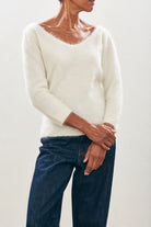 Female model wearing Jumper1234 cream brushed cashmere crew with front and back vee and 3/4 length sleeves 