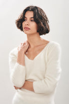 Female model wearing Jumper1234 cream brushed cashmere crew with front and back vee and 3/4 length sleeves 
