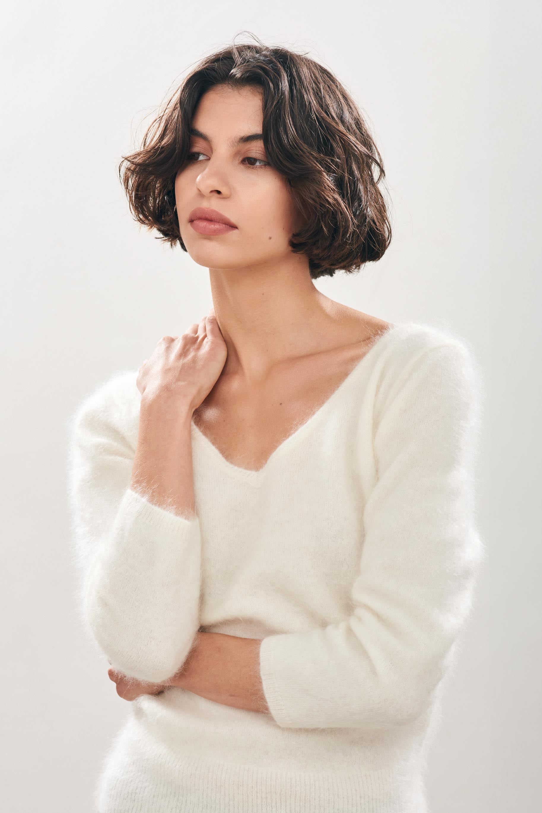 Female model wearing Jumper1234 cream brushed cashmere crew with front and back vee and 3/4 length sleeves 