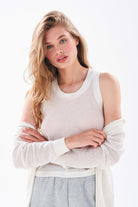 Model wearing Jumper 1234 cotton and cashmere White 'holey' zip up hoodie and matching vest