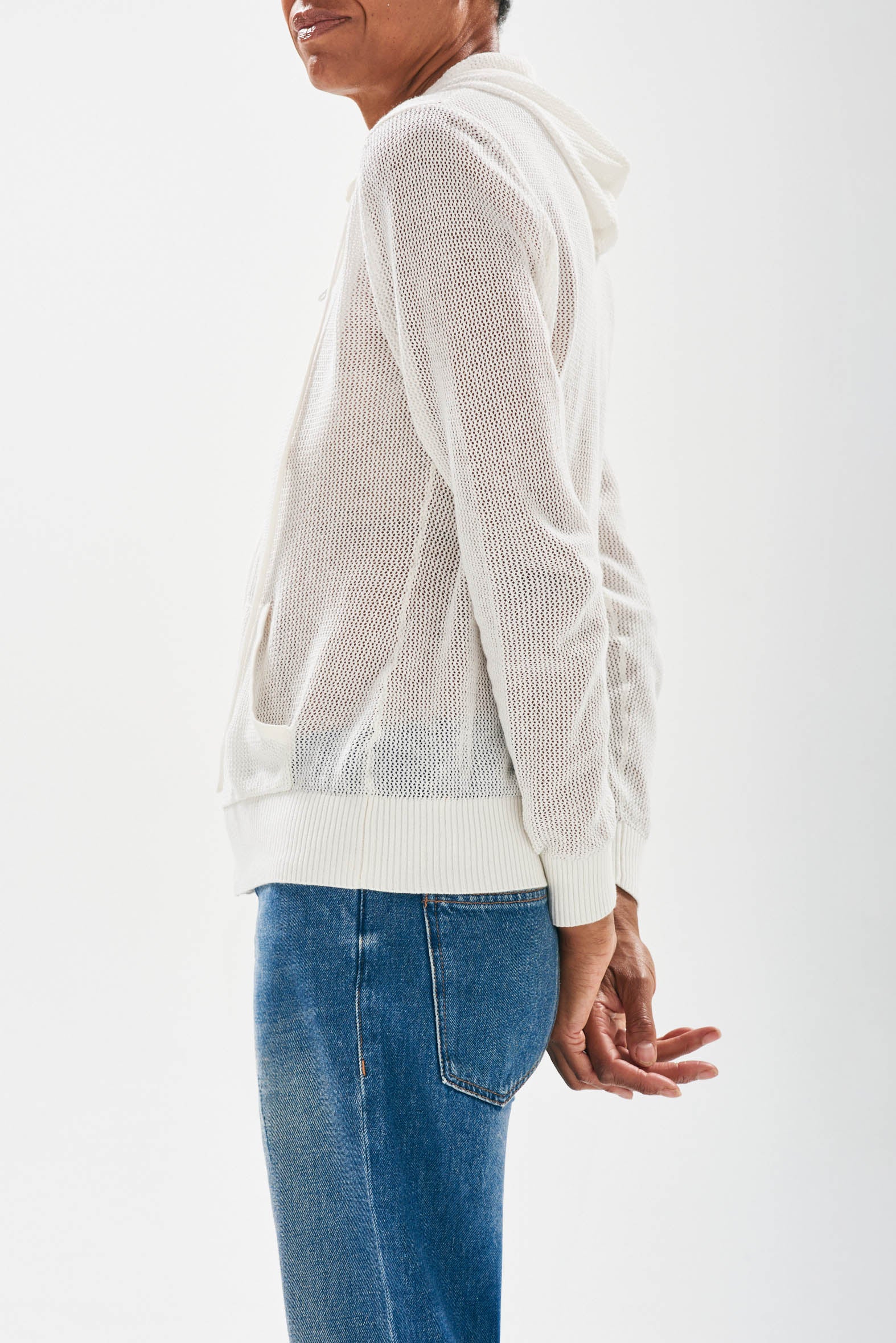 Model wearing Jumper 1234 cotton and cashmere White 'holey' zip up hoodie side view